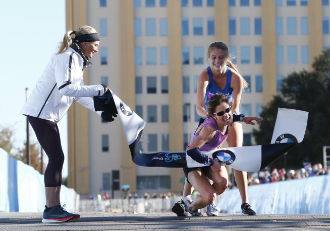 High School Student Carries Marathoner Across Finish Line