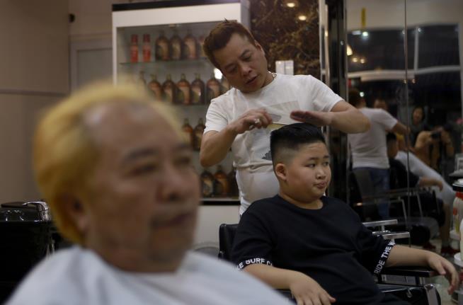 Hanoi Barber Giving Out Free Trump, Kim Hairdos