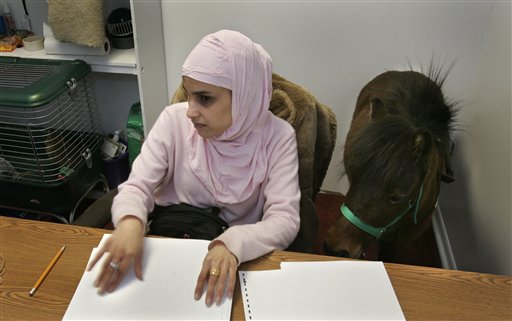 Muslim Woman Leans on Guide Horse