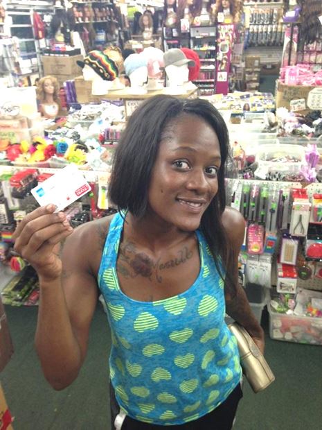 Woman Poses for Clerk Holding Stolen Credit Card