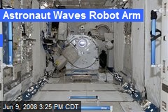 Astronaut Waves Robot Arm