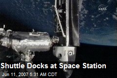 Shuttle Docks at Space Station