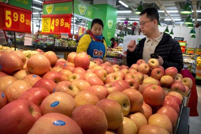 China raises tariffs on US pork, fruit in trade dispute
