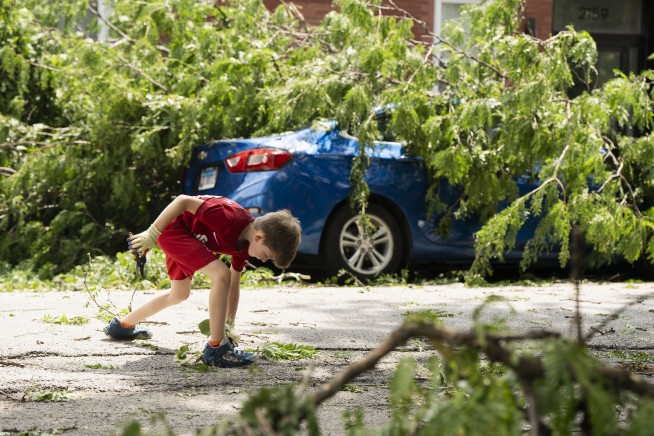 A dam fails after rain, wind, tornadoes pound the Midwest. The Chicago area is cleaning up