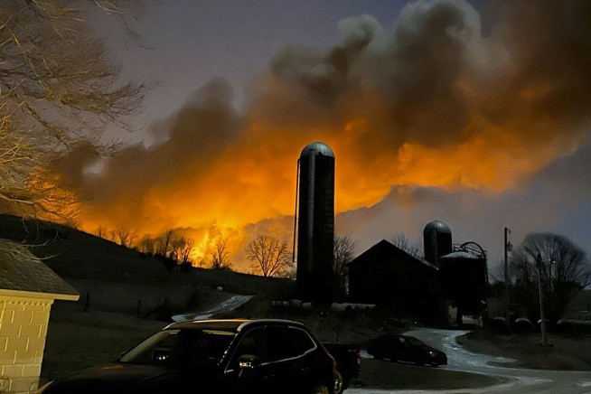 Crews release toxic chemicals from derailed tankers in Ohio
