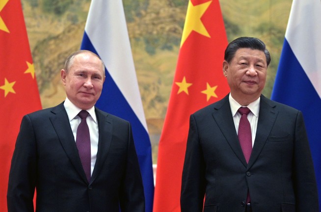 Amid crisis in Ukraine, Putin in Beijing praises China ties