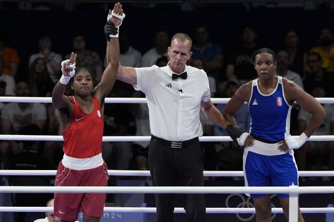 Boxer Cindy Ngamba becomes first athlete competing as a refugee to clinch an Olympic medal