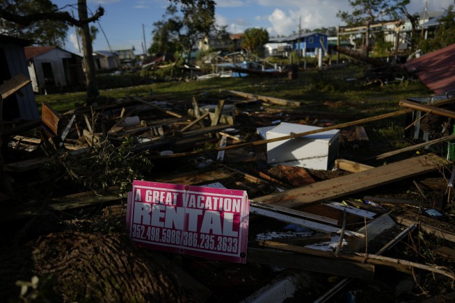 Residents pick through the rubble of lost homes and scattered belongings in Hurricane Idalia's wake
