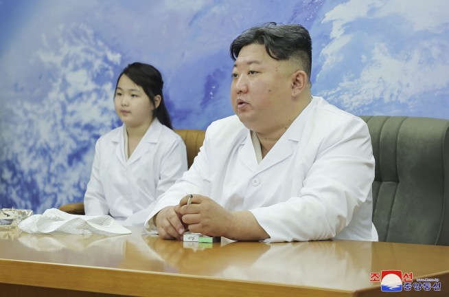 North Korea shows Kim Jong Un examining a military spy satellite that may be launched soon