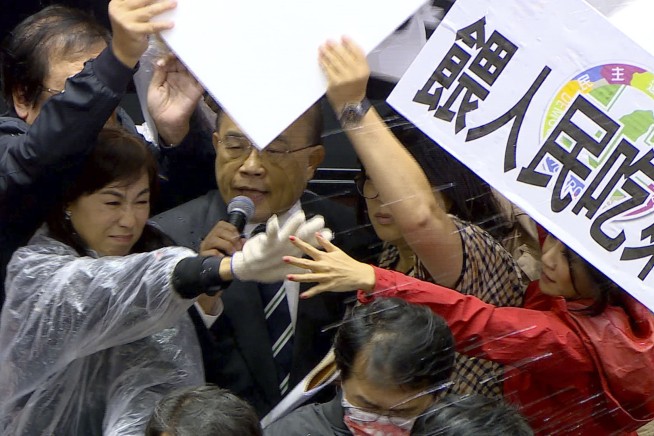 Lawmakers throw pig guts, punches on Taiwan parliament floor