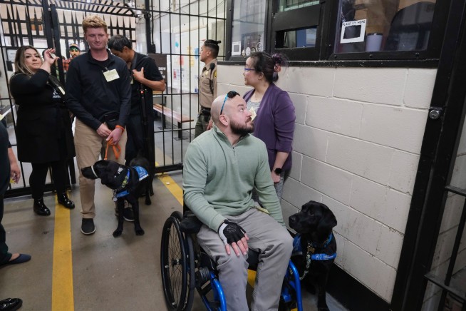 With tears and tail wags, San Quentin inmates reunite with puppies they raised into service dogs