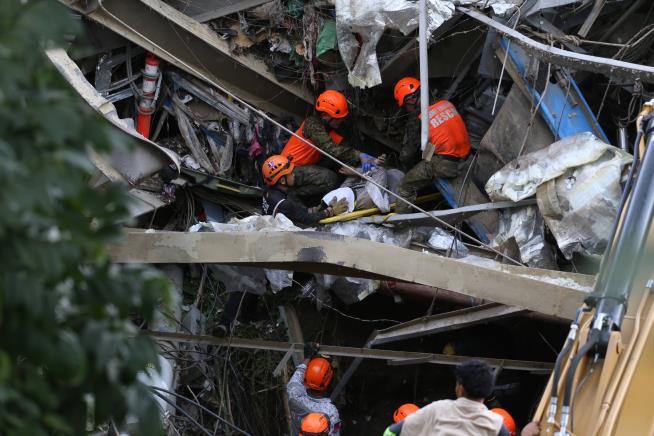 Mound of garbage collapses at Philippine landfill, killing 2 and leaving 36 others missing