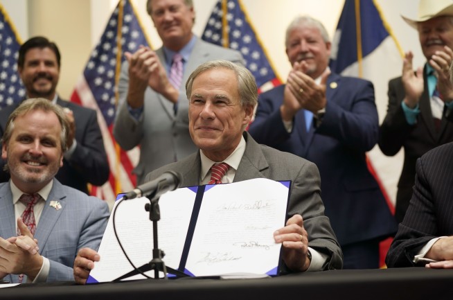 Texas governor signs new GOP voting restrictions into law