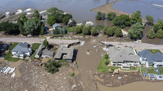 Midwestern flooding collapses a bridge, forces evacuations and kills at least 2