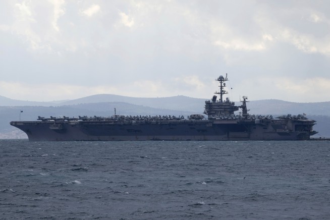 Fighter jet slips off the hangar deck of a US aircraft carrier in the Red Sea, one minor injury