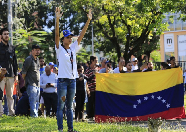 The Latest: Venezuela: Civilians, deserter in base attack
