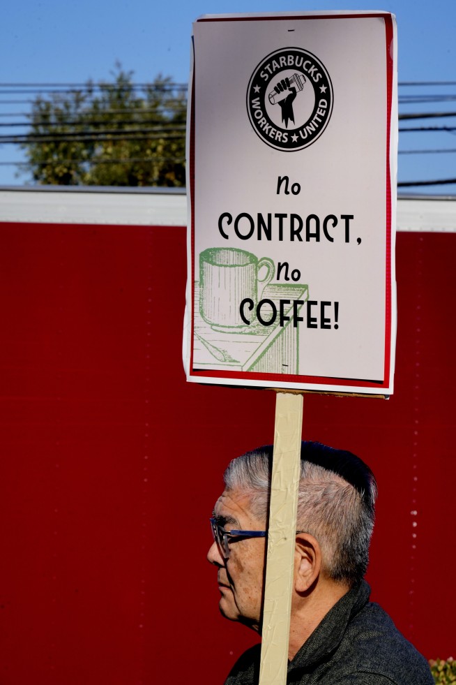 Starbucks workers begin strikes that could spread to hundreds of US stores by Christmas Eve
