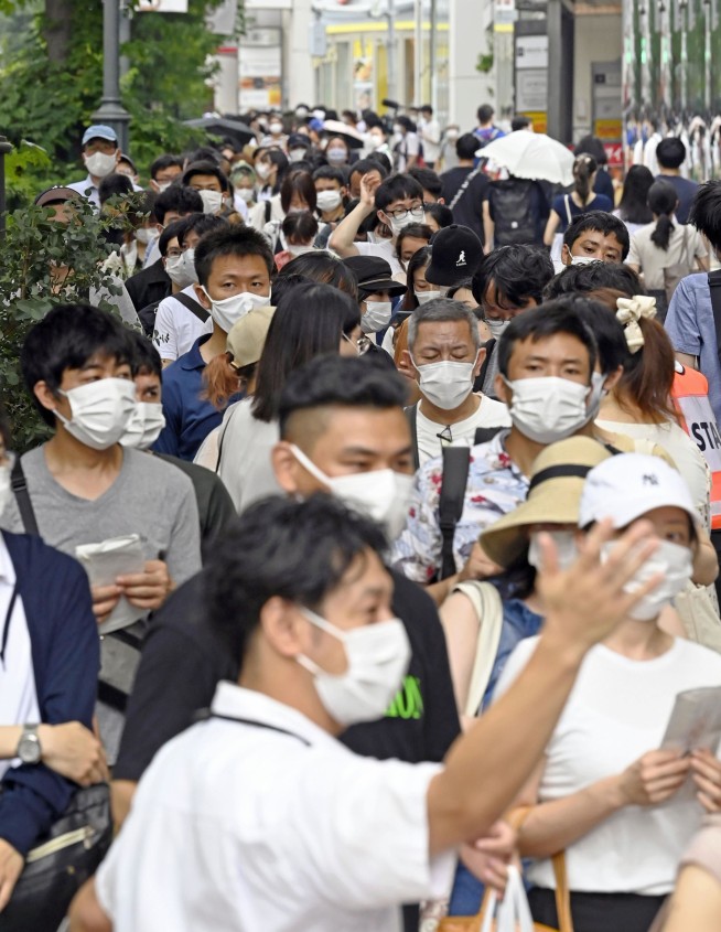 Vaccines, masks? Japan puzzling over sudden virus success
