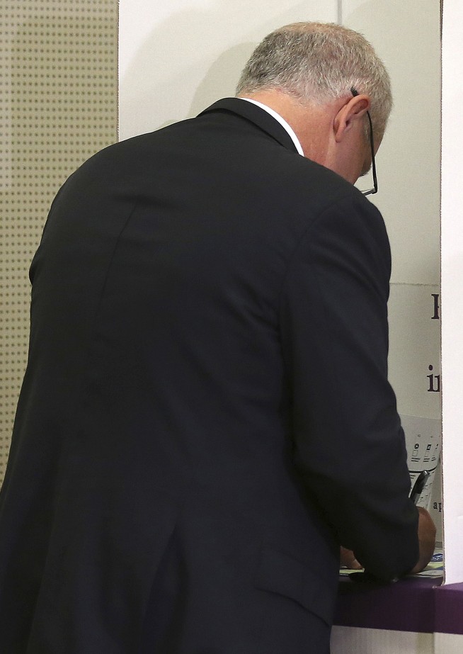 Australia's ruling coalition elected to surprise third term