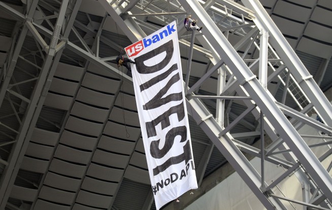 Oil pipeline protesters unfurl huge banner at Vikings game