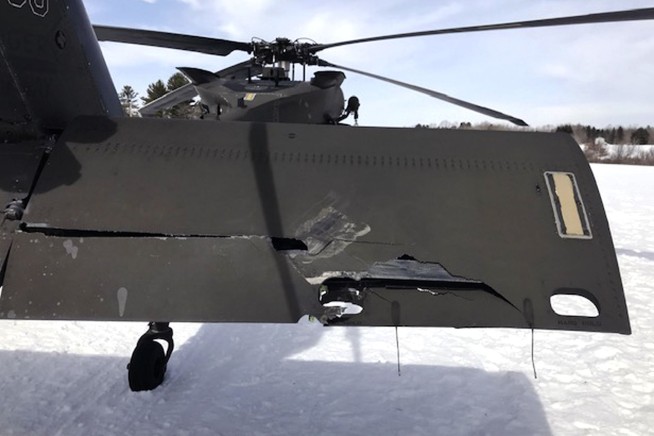 A man who crashed a snowmobile into a parked Black Hawk helicopter is suing the government for $9.5M