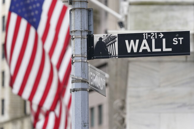 Stocks end mixed after a day of wavering; bond yields fall