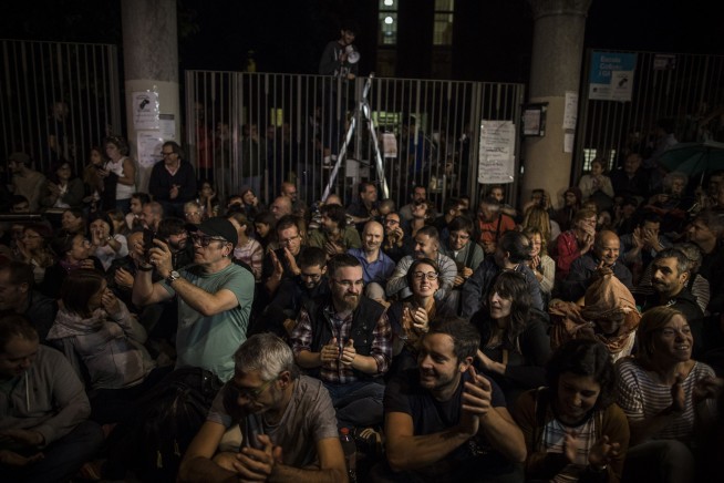 The Latest: Spanish police beat, kick people in Catalonia