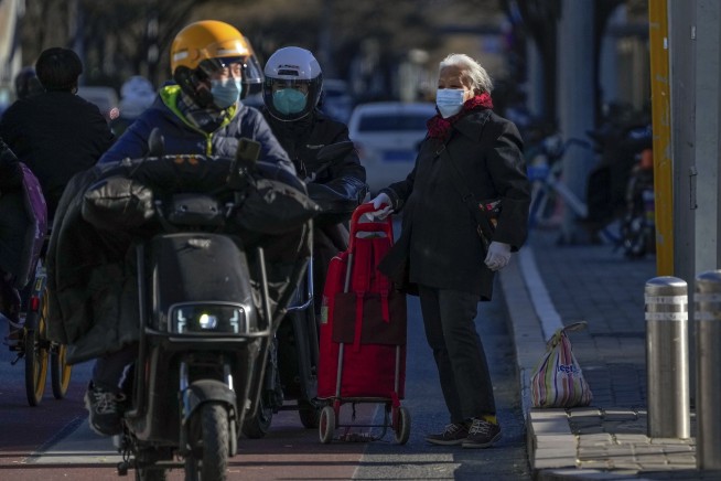 China eases virus controls amid effort to head off protests