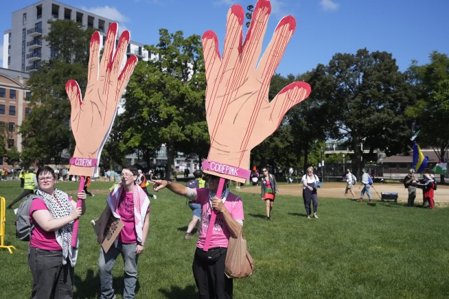 Some protesters tear down security fence as thousands march outside Democratic National Convention
