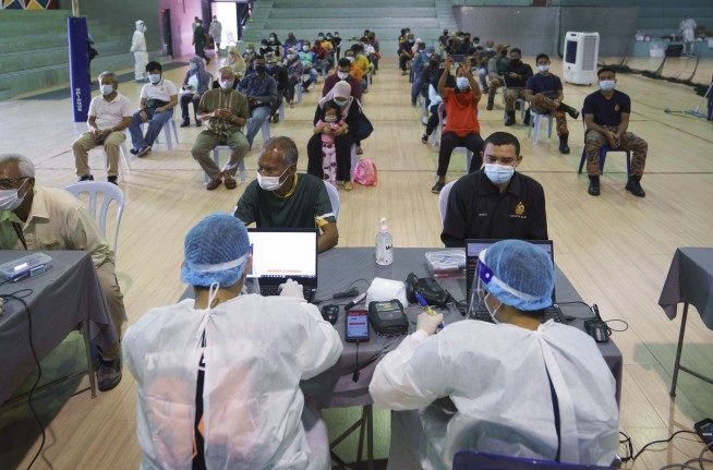 The Latest: UK approves trial exposing volunteers to virus