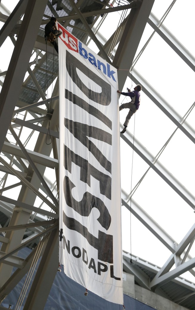 Oil pipeline protesters unfurl huge banner at Vikings game