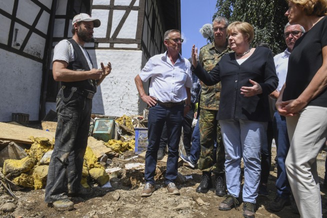 Merkel tours 'surreal' flood scene, vows aid, climate action