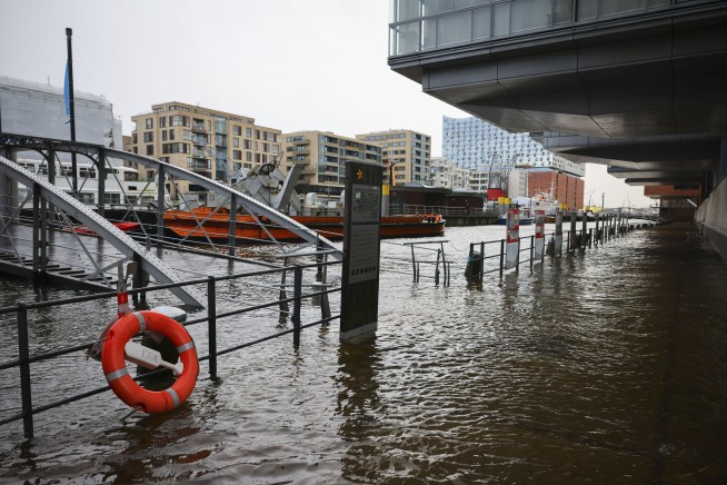 A storm brings strong winds to northern Europe, killing 2 people and disrupting transport