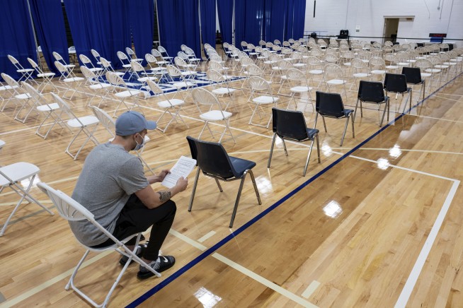 The Latest: Crowded sport stadiums, virus combustible mix