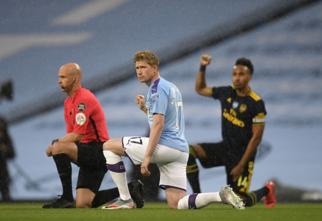 After 100-day wait, English soccer returns and takes a knee