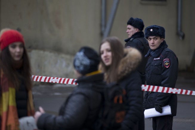 Russian police arrest woman seen waving child's head