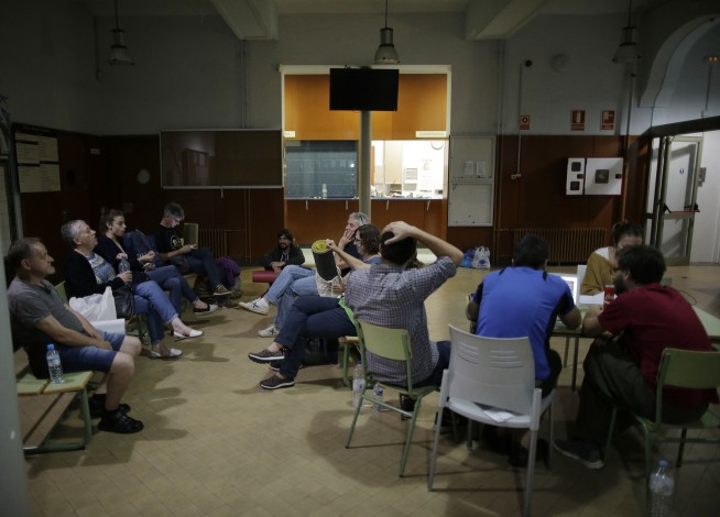 Parents occupy schools to defend Catalan vote, face deadline