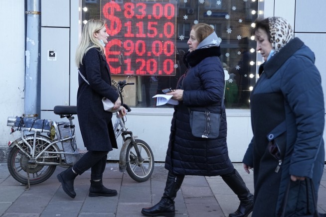 Ruble plummets as sanctions bite, sending Russians to banks