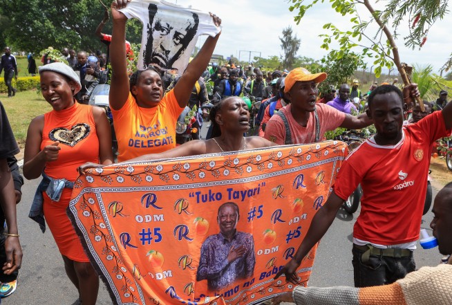 Kenya police fire at mourners and 2 die as violence erupts at viewing of body of ex-Premier Odinga