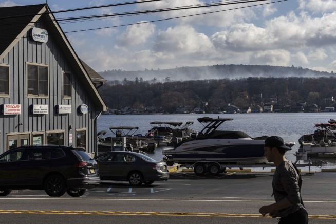 Fire crews on both US coasts battle wildfires