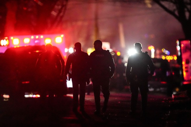 Gunshots and then a fire at a suburban Philadelphia home leave 2 officers wounded, 6 people missing