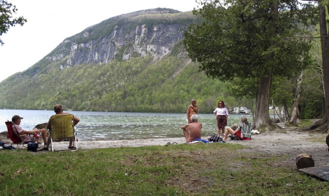 Vermont nude beach fans against parking lot, boardwalk