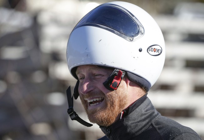 Prince Harry races head-first down a skeleton sled track and says 'everybody should do this'