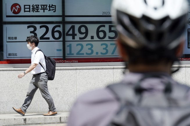 Stock market today: Asian shares fall as strong US data dash hopes for an end to rate hikes
