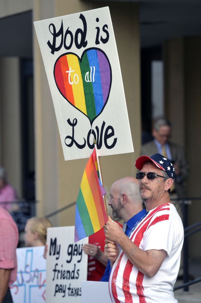 The Latest: Judge warns deputy clerks they must comply