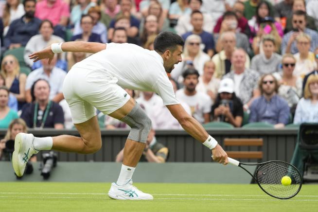 Novak Djokovic wins his first match at Wimbledon with a sleeve on his ...