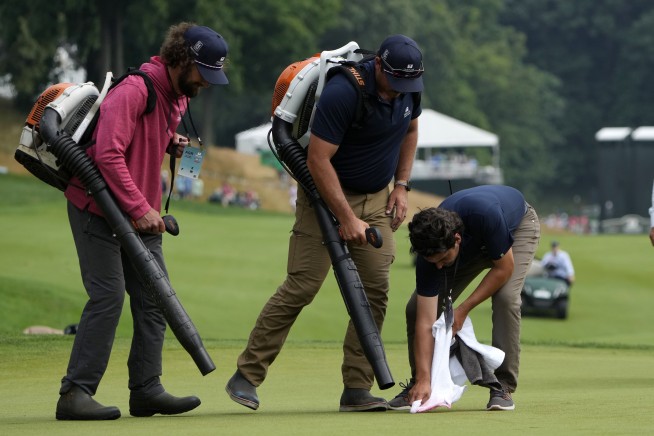 Six climate protesters run onto 18th green and spray powder, delaying finish of PGA Tour event