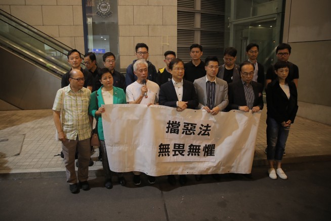 Hong Kong pro-democracy lawmakers charged, student mourned
