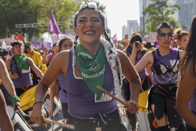 Facing historic shifts, Latin American women bathe streets in purple on International Women's Day