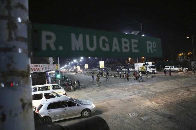 Zimbabwe army controls broadcaster, says Mugabe, wife safe